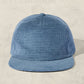 Blue textured cap on a beige background