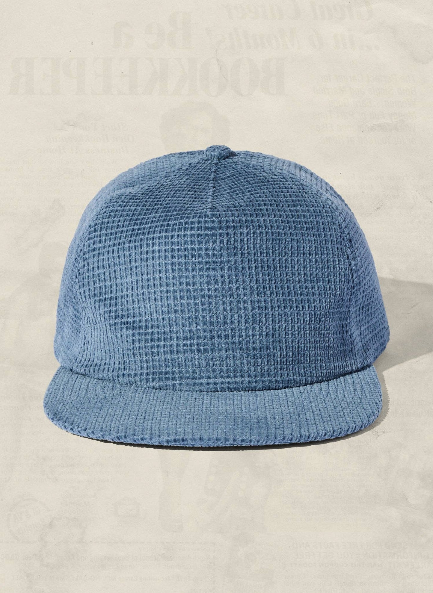 Blue textured cap on a beige background