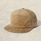 Beige textured cap on a light beige background