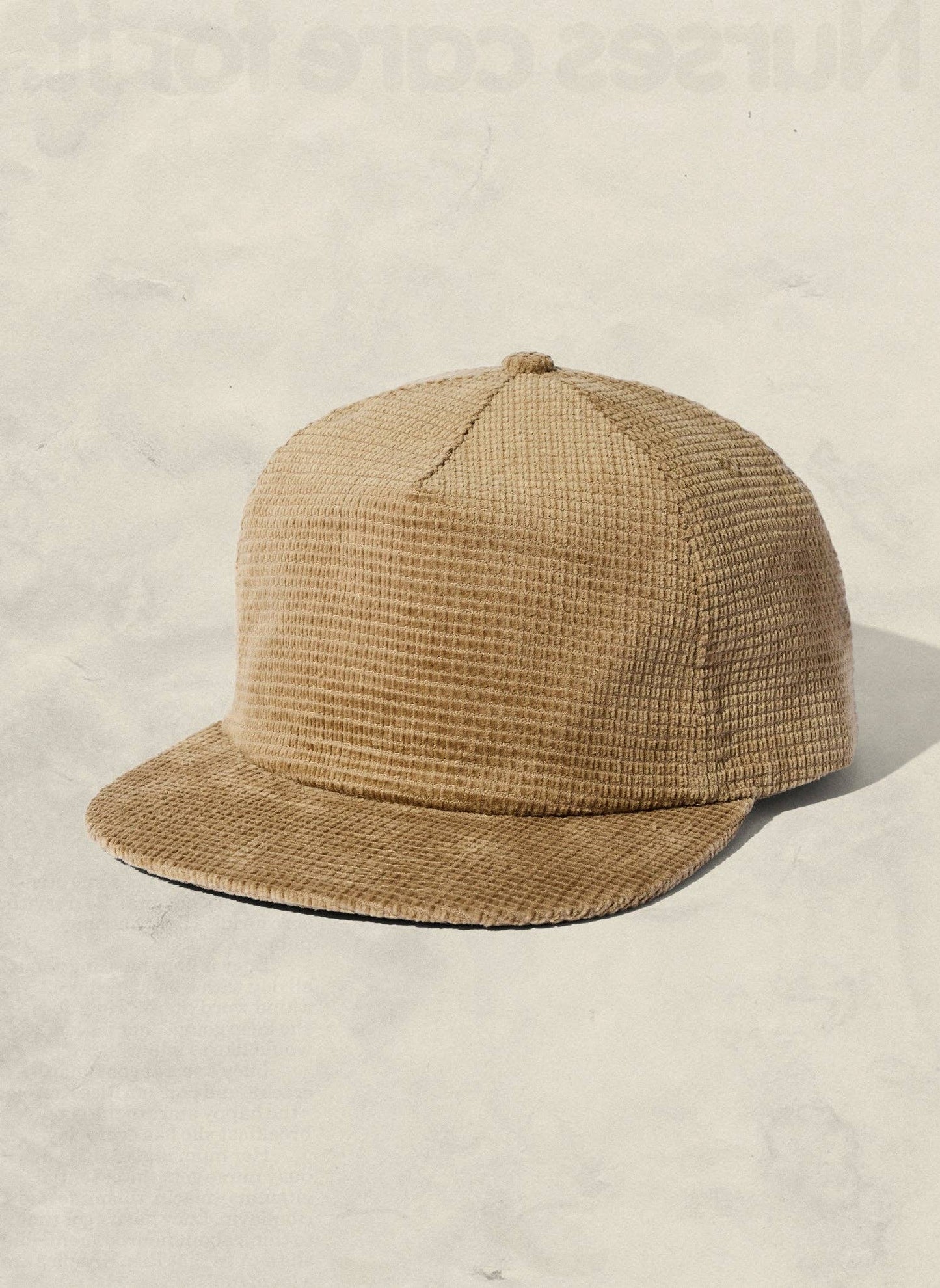 Beige textured cap on a light beige background