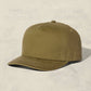 Olive green cap on a beige background