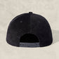 Black cap on a beige background