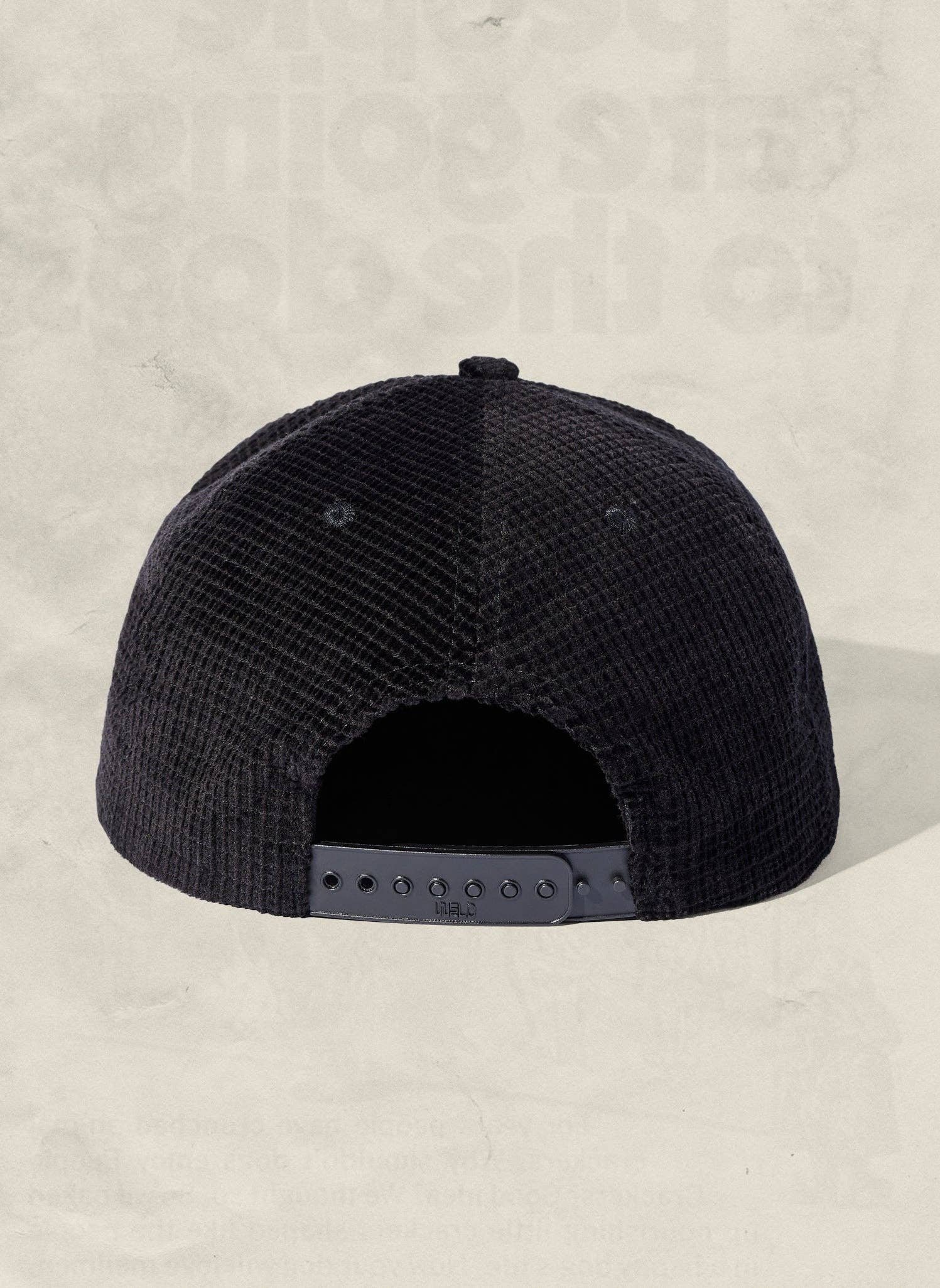 Black cap on a beige background