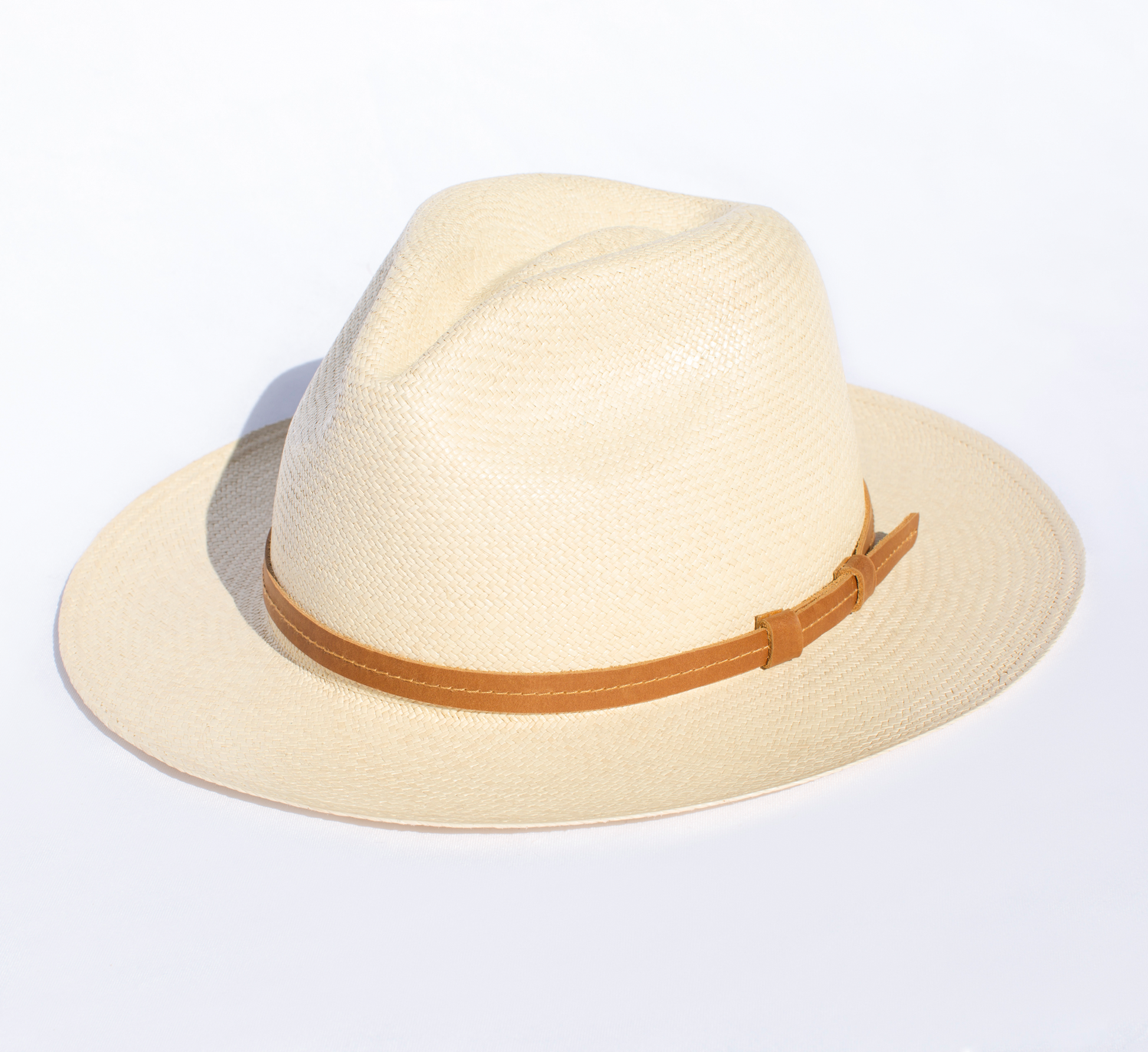 Beige straw hat with a brown band on a white background