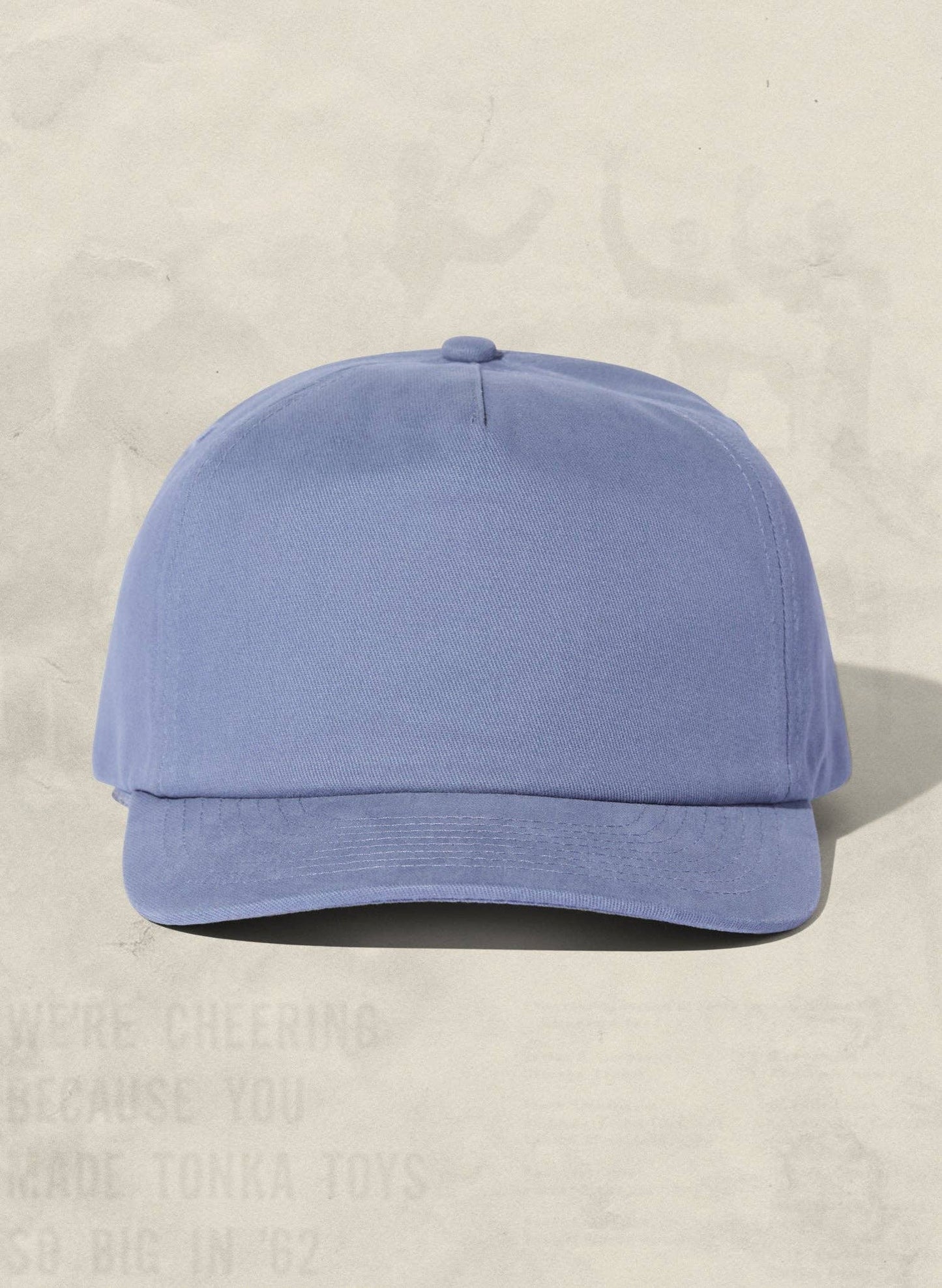 Blue baseball cap on a beige background