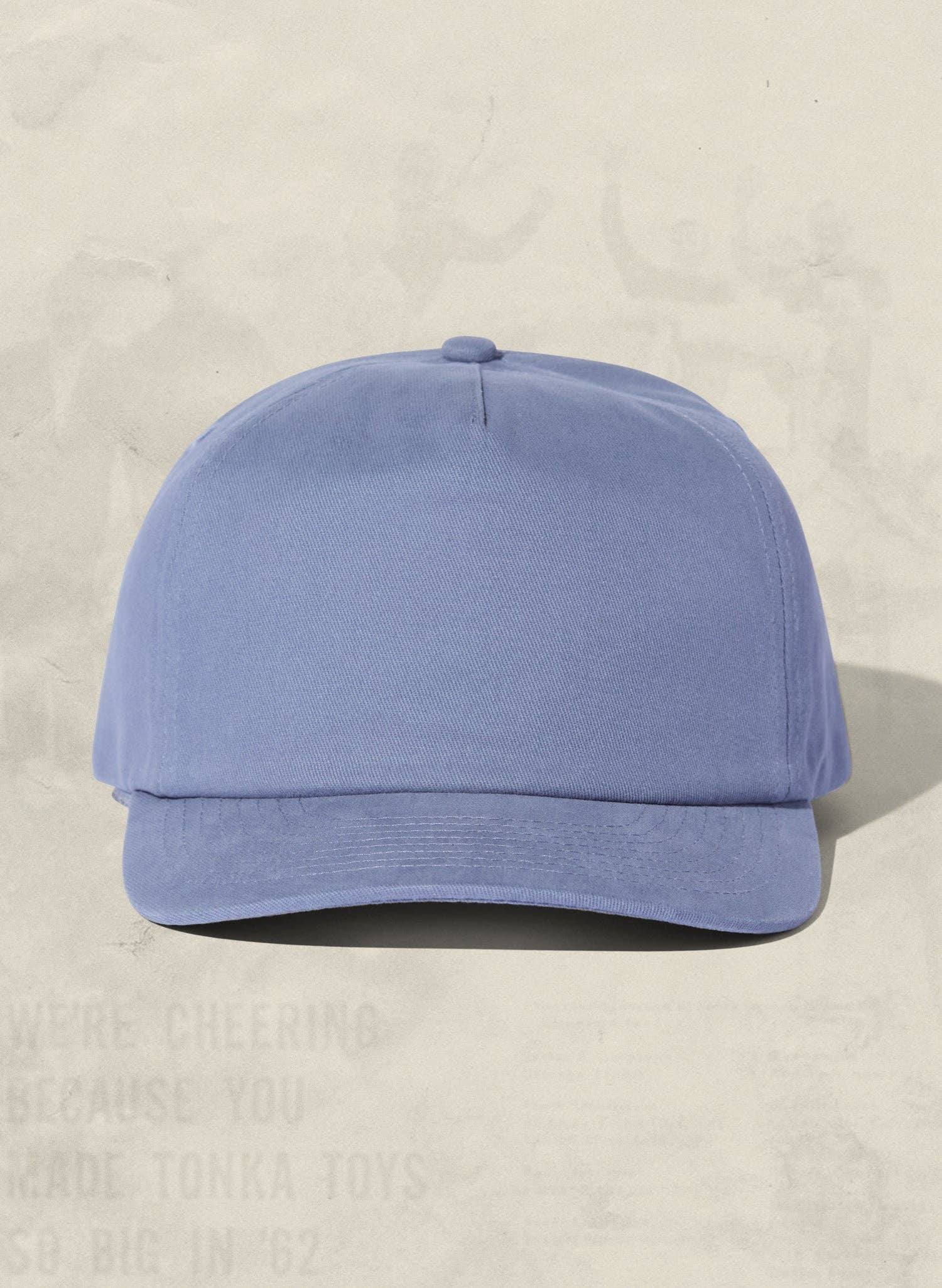 Blue baseball cap on a beige background