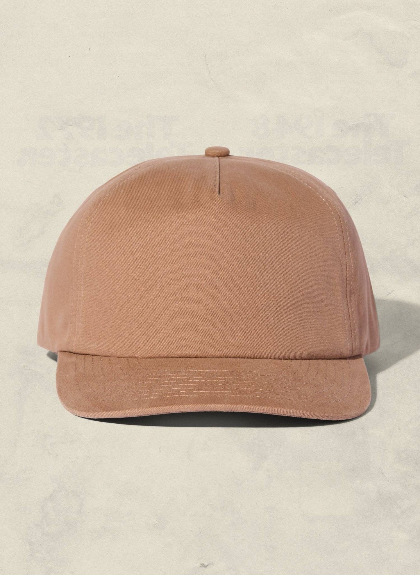 Brown baseball cap on a beige background