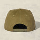 Olive green cap on a light beige background