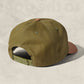 Green cap on a beige background