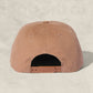 Brown cap on a beige background