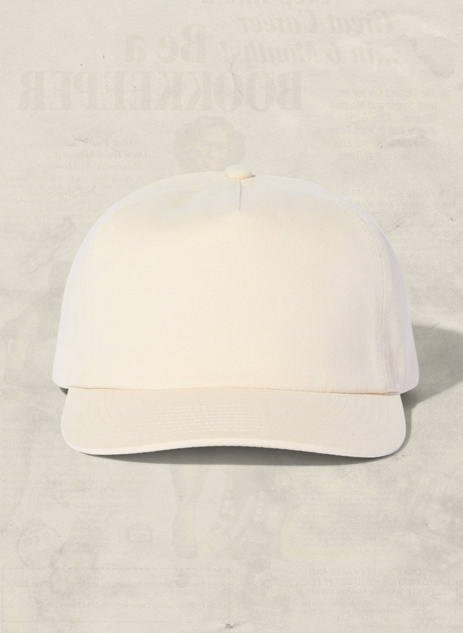 White baseball cap on a light beige background