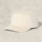 White cap on a textured beige background