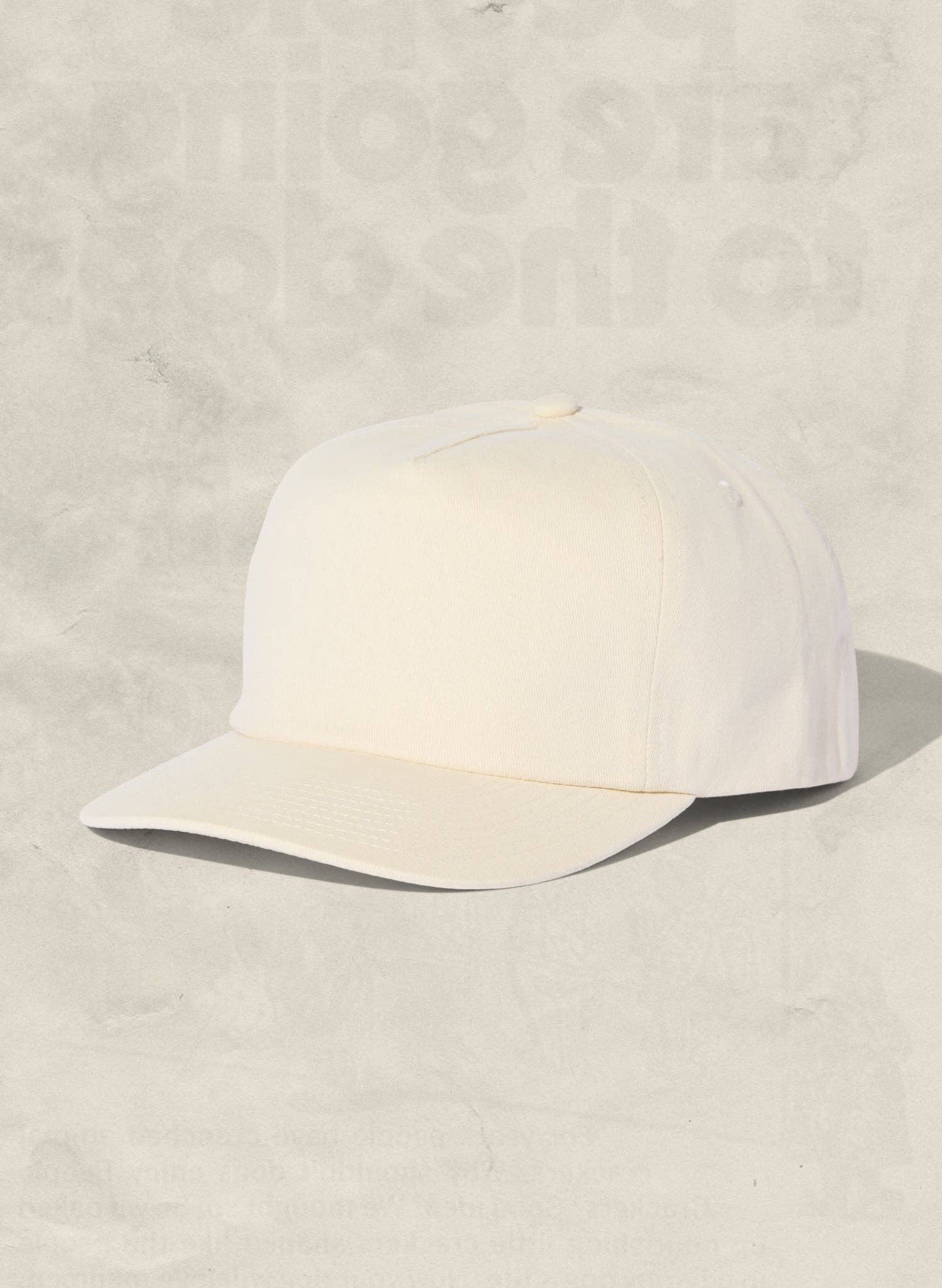 White cap on a textured beige background
