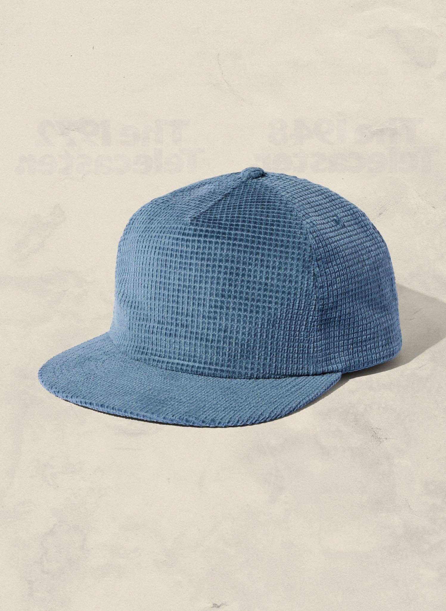 Blue checkered cap on a beige background