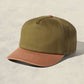 Green and brown cap on a beige background