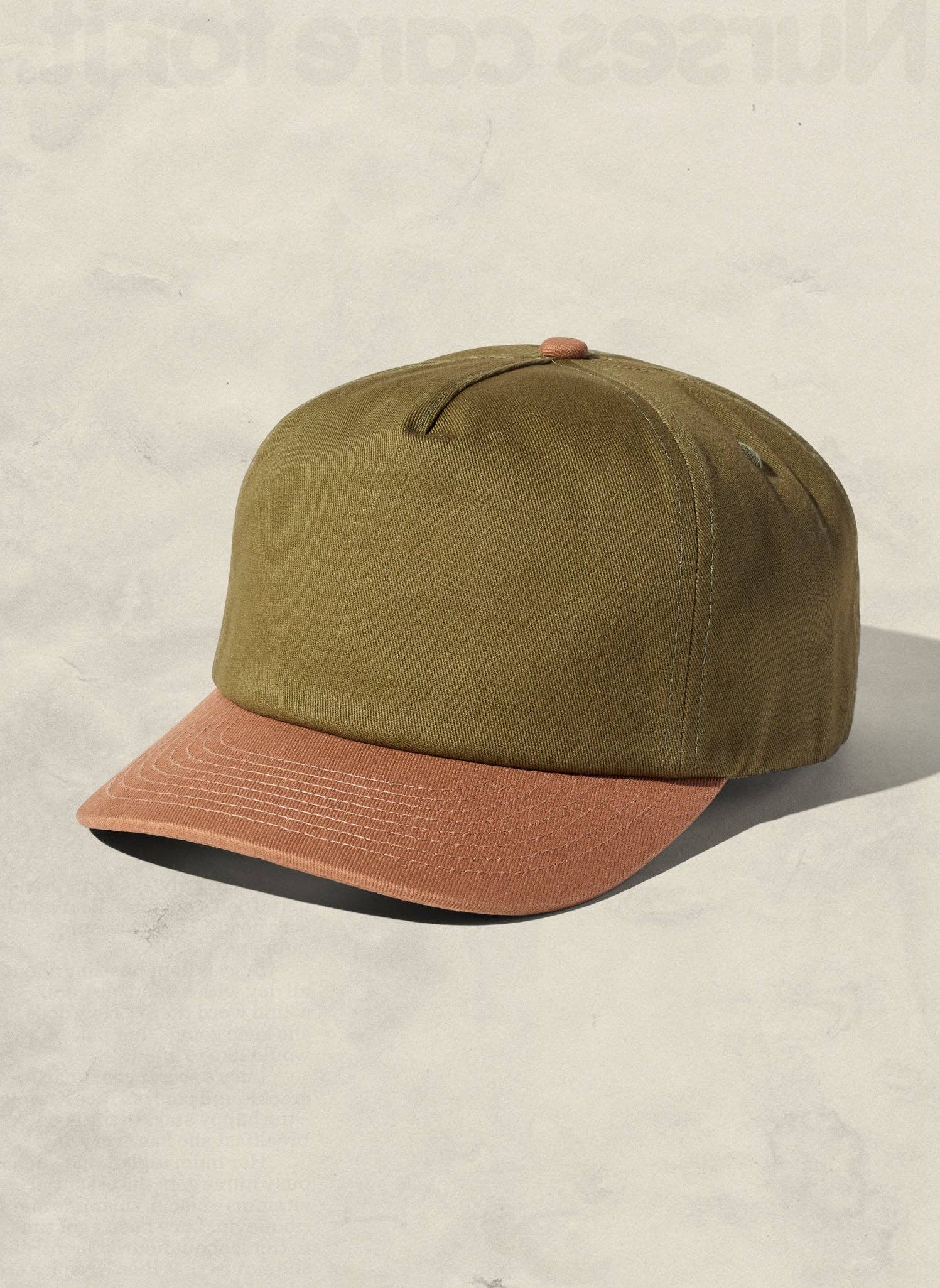 Green and brown cap on a beige background