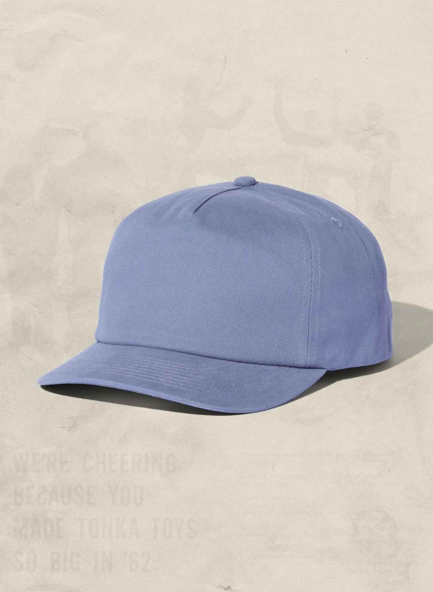 Blue baseball cap on a beige background