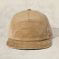 Beige waffle-textured cap on a light beige background